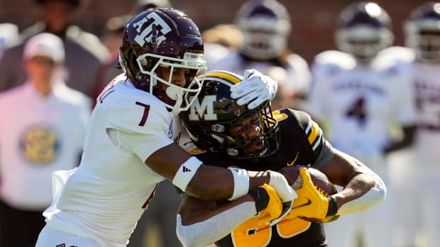 Oct 16, 2021; Columbia, Missouri, USA; Missouri Tigers wide receiver Tauskie Dove (86) is tackled by Texas A&M Aggies defensive back Tyreek Chappell (7) during the first half at Faurot Field at Memorial Stadium.